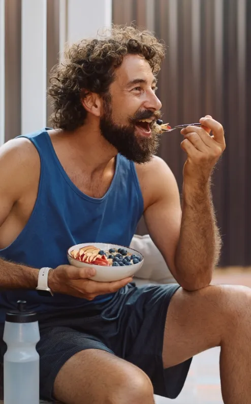 happy sportsman enjoying in fruit oatmeal after wo utc