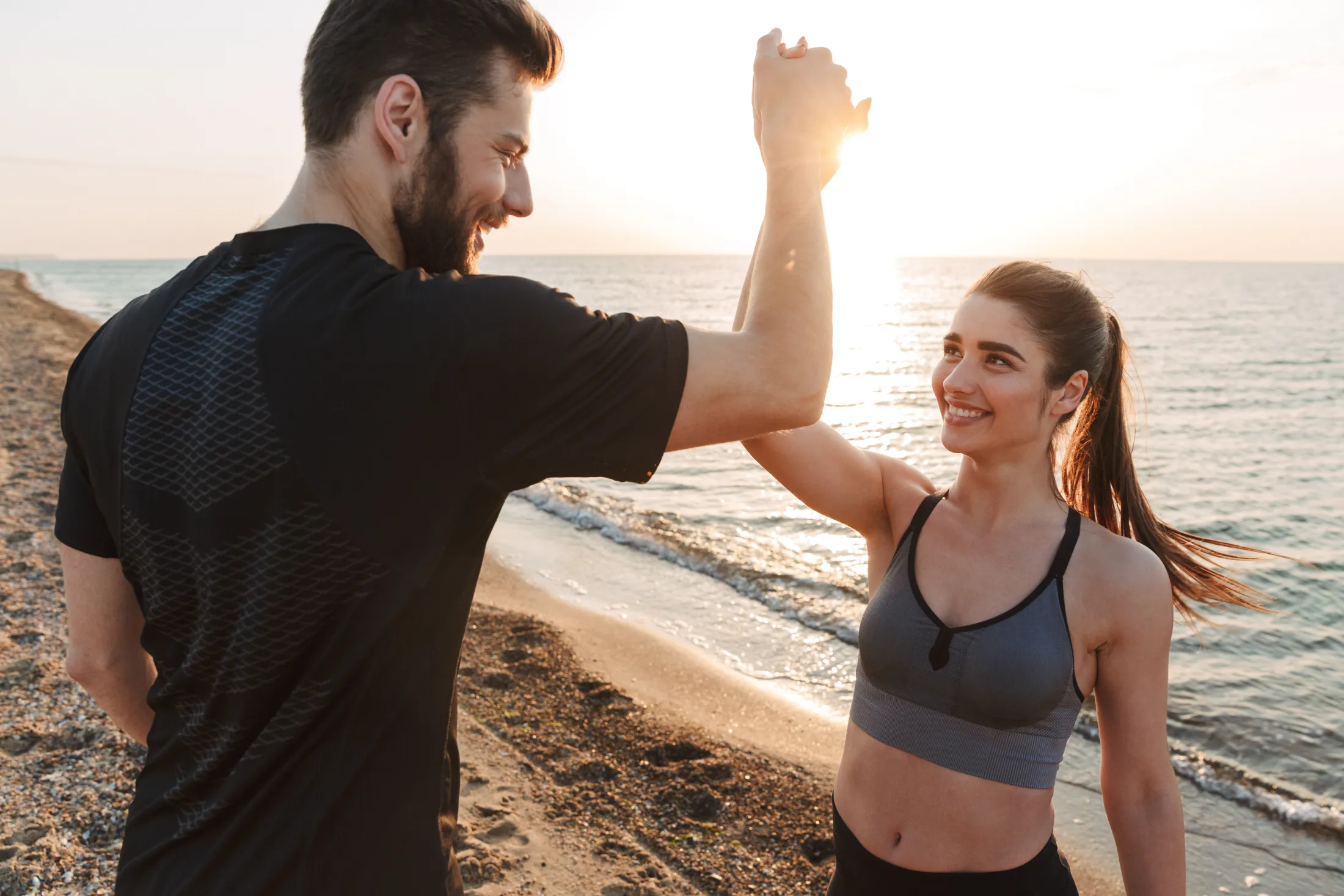 happy young couple giving high five while standing utc