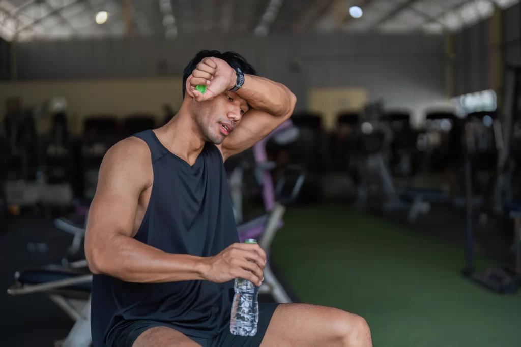 hydration and fitness man taking a break in gym utc