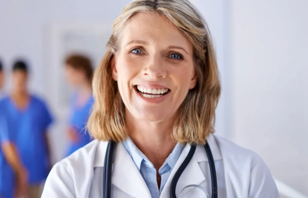 portrait of a mature female doctor with a group of utc