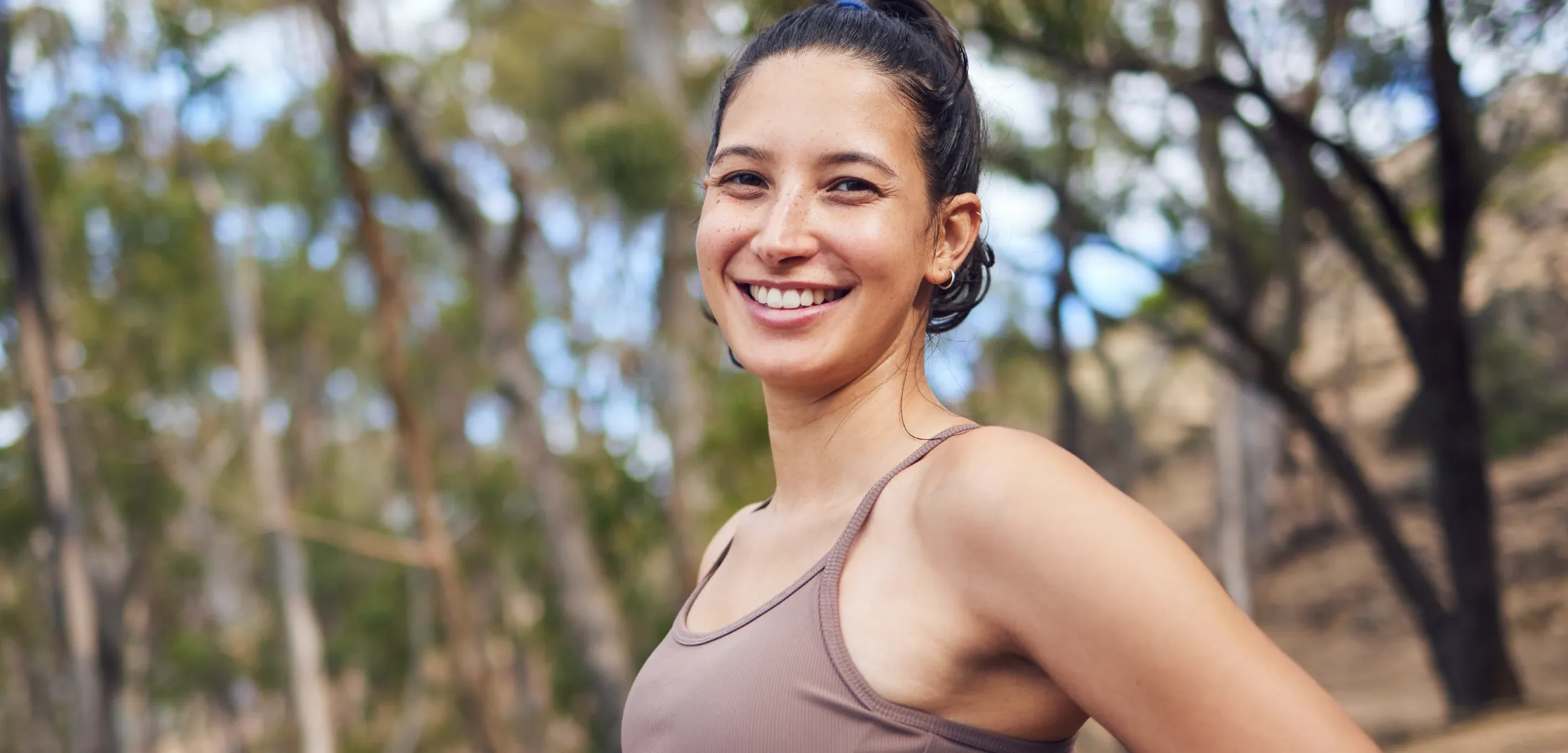 portrait of a sporty young woman standing with her utc