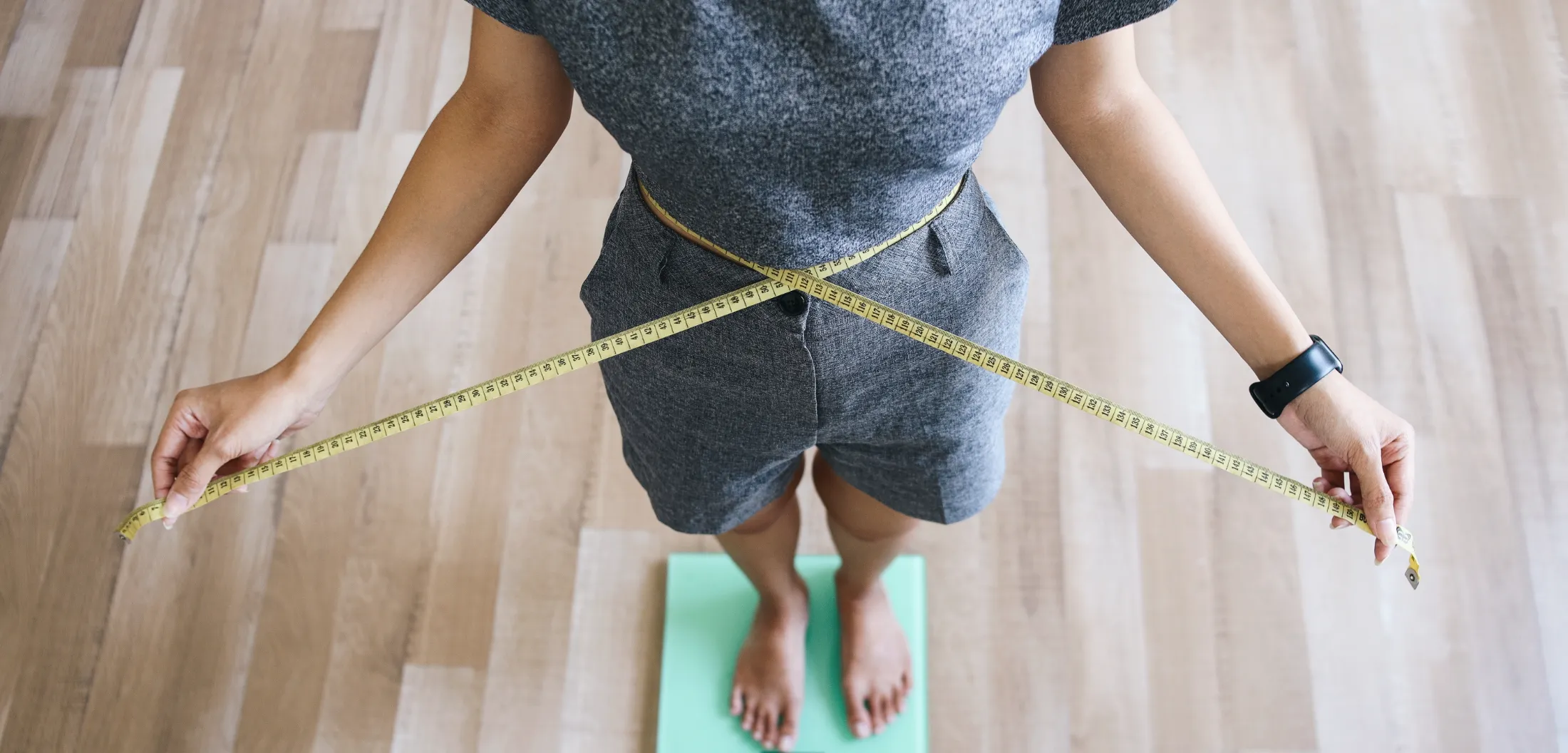 slim girl measure waist and weighing body utc