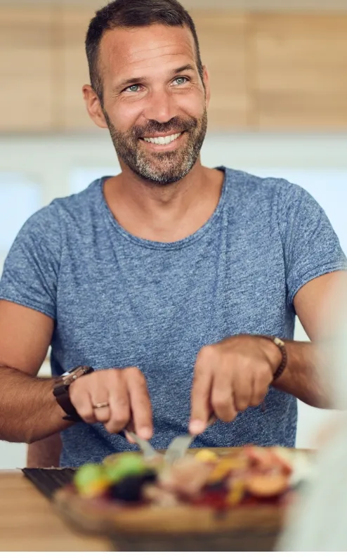 smiling man enjoying a meal in a bright modern ki utc